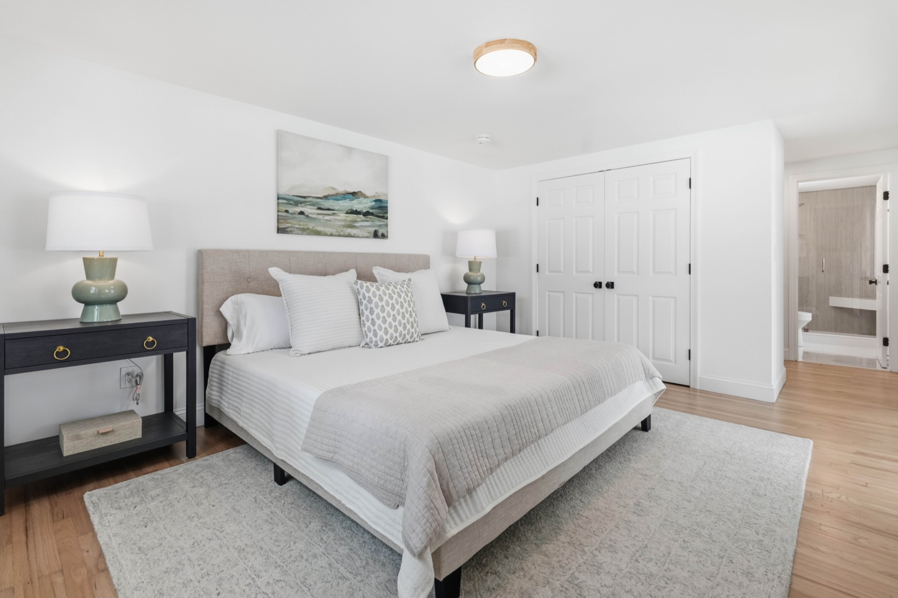 Calm first-floor primary bedroom with ensuite bath